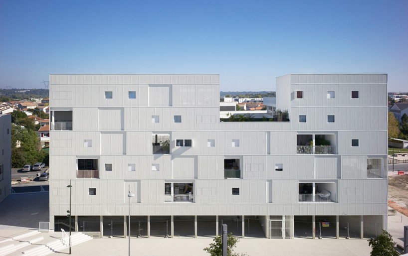 LAN architecture rhythmically inserts windows + balconies in french community housing