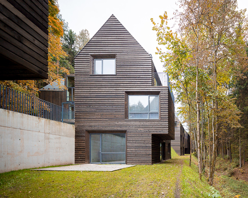 paleko + plazma nestles wooden housing development in a lithuanian nature reserve