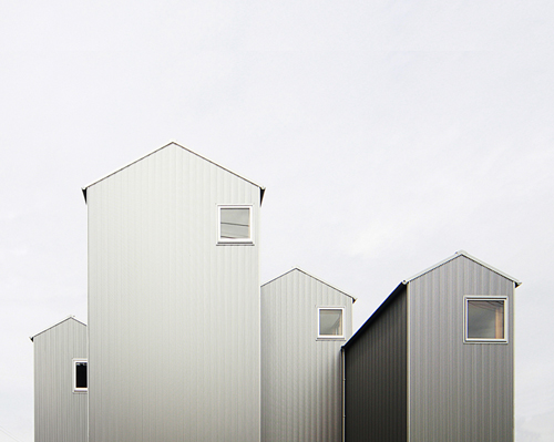 shuhei goto's residence in kosai rises as a series of house-shaped towers