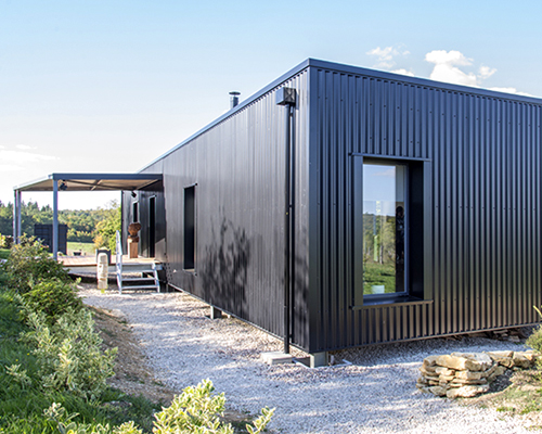 spray architecture inserts two-container home at the edge of the woods in france