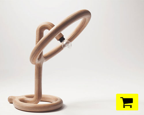 studio roex's streamlined table lamp lights up all layers of plywood