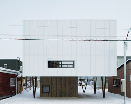 archi LAB uses pilotis to elevate japanese home from rising snowfall