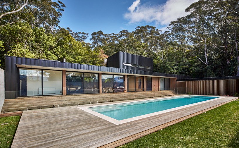 modscape conceals modular pool-side home in australia with rendered brick-wall