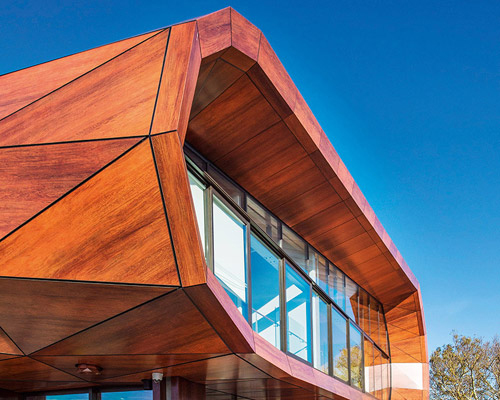 archimedia designs faceted te oro community center in auckland