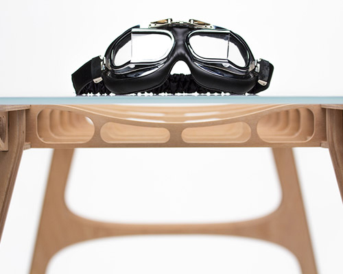 manfred table explores the sculptural structure of wooden airplane wings