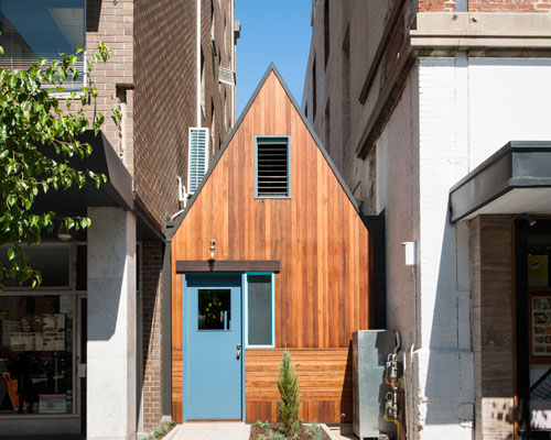 sans-arc studio tucks pink moon saloon into alleyway in australia