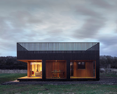 IPT architects clads howe farm residence in charred timber planks