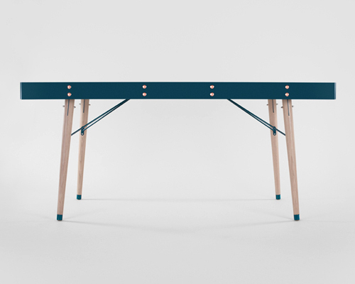 miltonpriest assembles communauté dining table with hand-buffed copper rivets