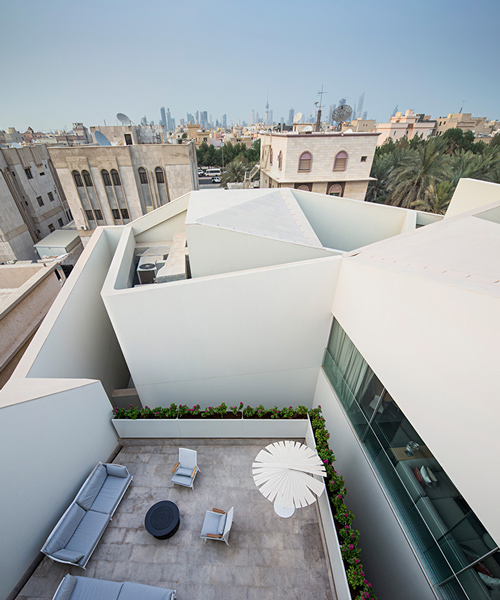 AGi architects hides wall house in kuwait behind monumental stone façade