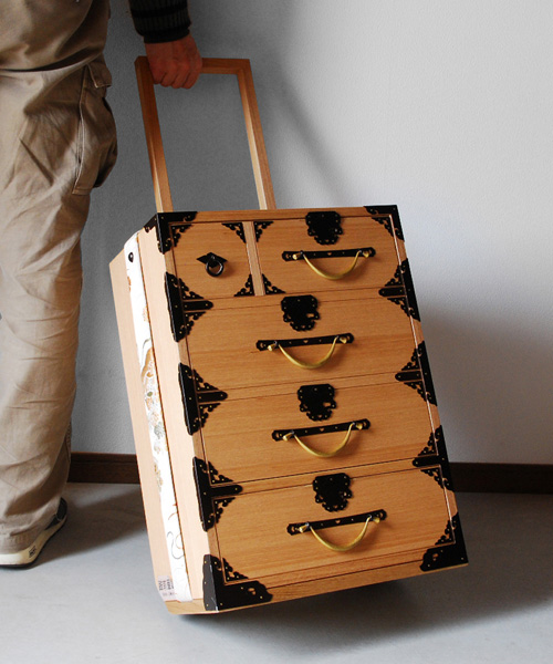 yuukou yamaguchi turns traditional japanese tansu chests into contemporary trolley cases