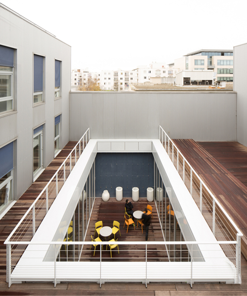 FUSO cuts warehouse to create patios that let light flow through offices in paris