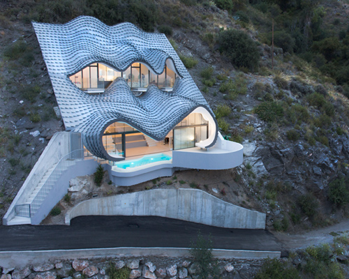 gilbartolomé buries metallic scaled residence into a cliff overlooking the mediterranean