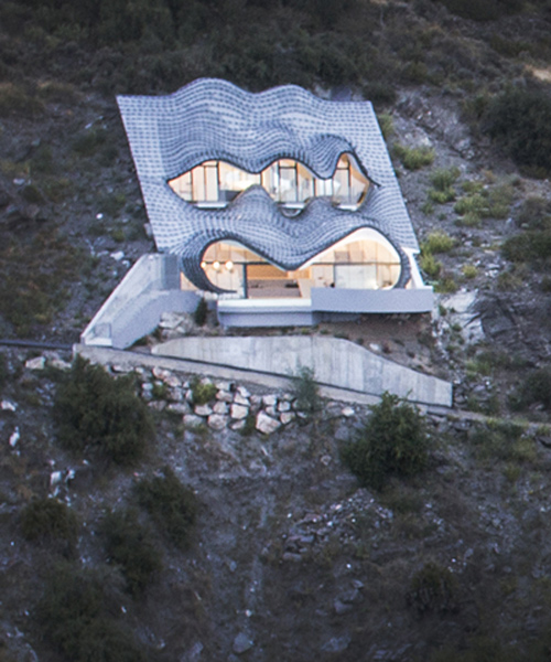 gilbartolomé buries metallic scaled residence into a cliff overlooking the mediterranean
