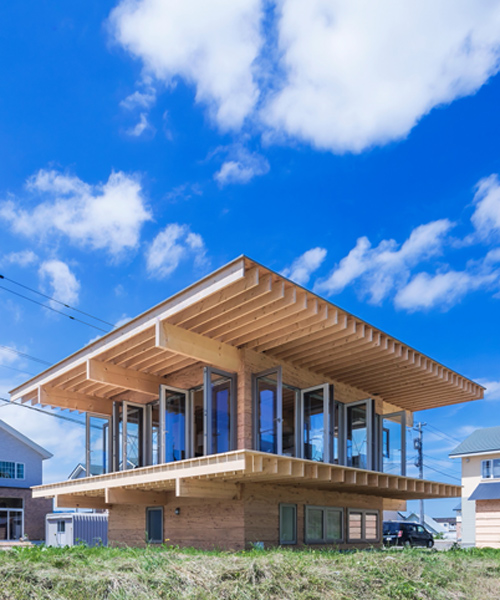 jun igarashi tops japanese residence with an oversized hat roof