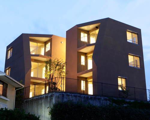 fukuoka apartment complex by tailored design lab weaves between trees