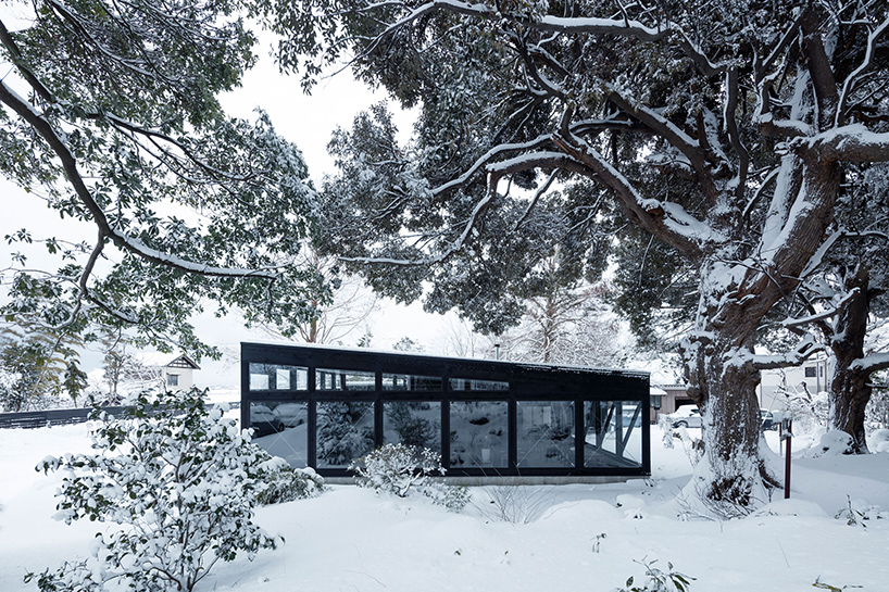 takuyahosokai immerses niigata community center within the natural landscape