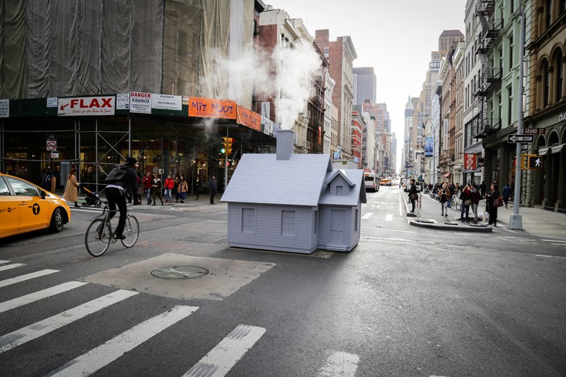 mark reigelman's puts miniature cabin on top of steaming manhole covers for smökers installation