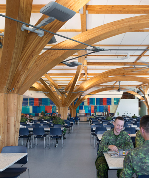 ZAS architects' canadian military dining hall features tree-like columns made of glu-lam
