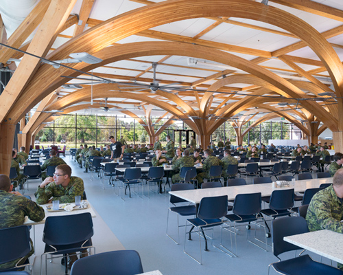 ZAS architects' canadian military dining hall features tree-like columns made of glu-lam