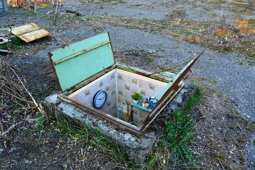 biancoshock hides miniature underground rooms inside manholes in milan