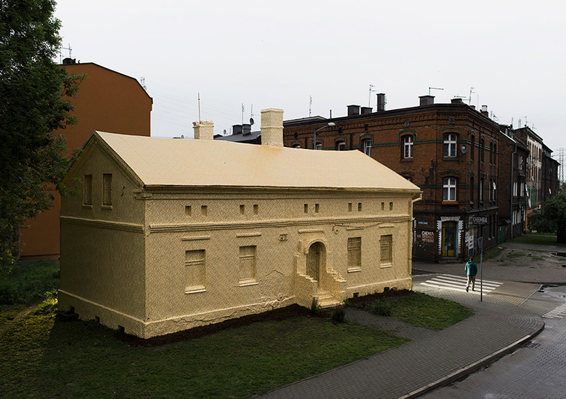 ian strange wraps historical building in poland with 600 sq meters of gold wallpaper