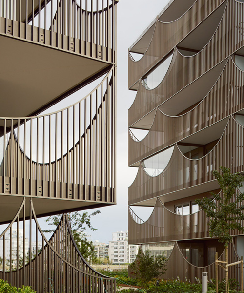 tham & videgård arkitekter's housing scheme in sweden has inverted arch balconies