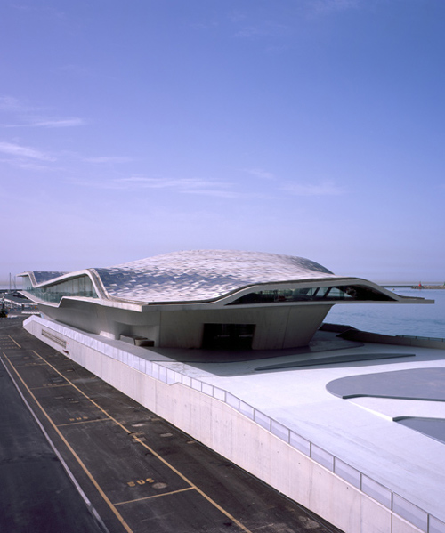 zaha hadid architects' ferry terminal in italy topped with asymmetric shell