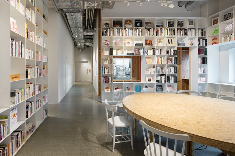 schemata combines a library and cake shop for tokyo based kitchen 'hue'