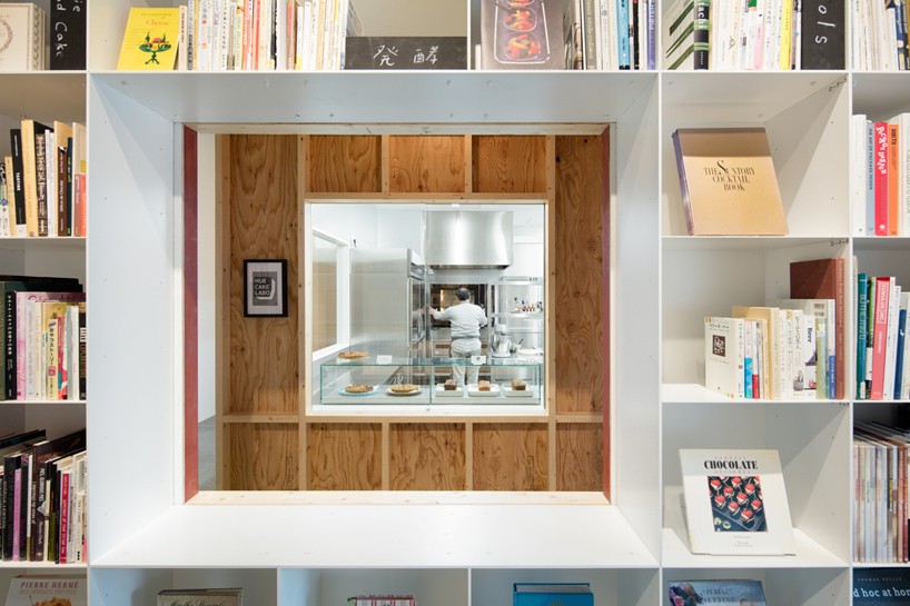 schemata combines a library and cake shop for tokyo based kitchen 'hue'