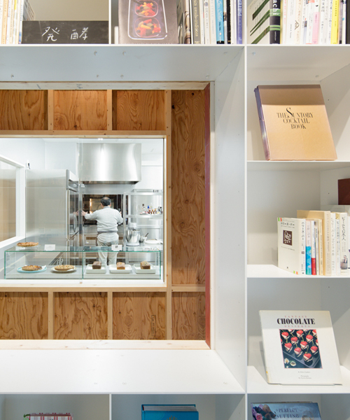 schemata combines a library and cake shop for tokyo based kitchen 'hue'