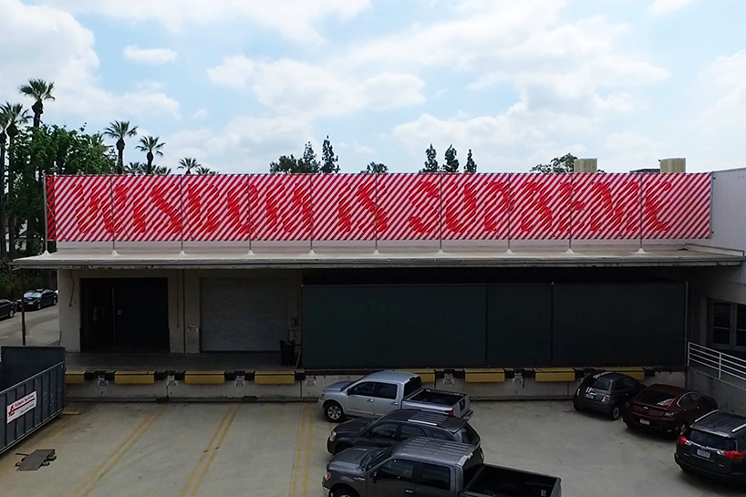 andrew byrom's typographic installation animates when viewed by passing trains