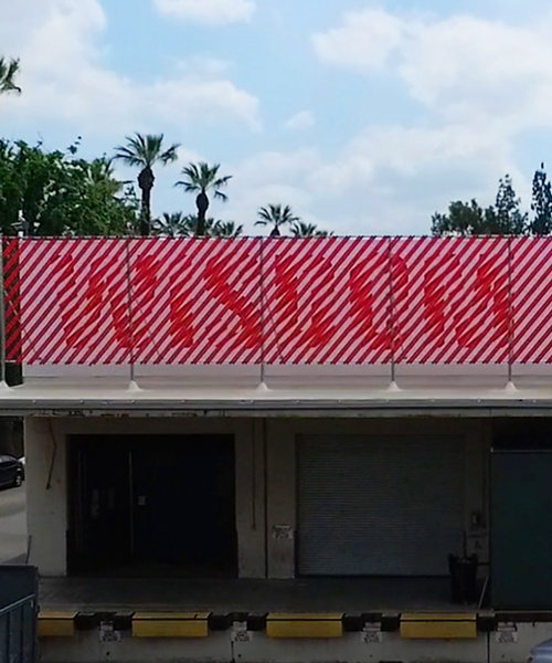 andrew byrom's typographic installation animates when viewed by passing trains