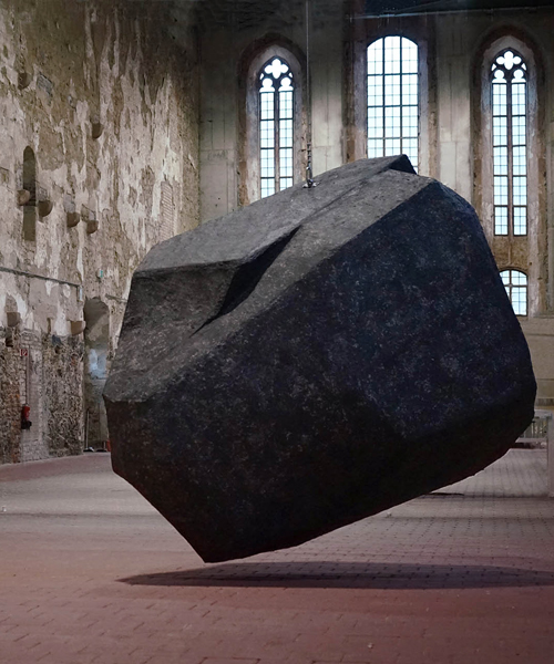 BORGMAN | LENK suspends behemoth 'boulder' within a monastery near leipzig