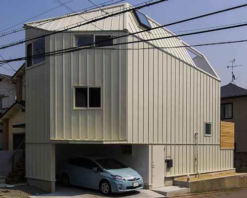 angular residence by coo planning sits on a corner plot in hyōgo, japan