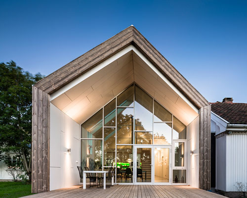 LINK arkitektur wraps contemporary gabled extension with kebony wood in norway