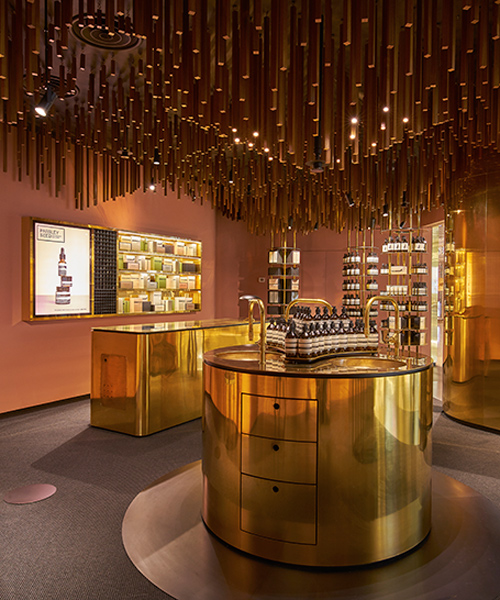 snøhetta suspends timber battens from the ceiling of singapore's aesop ION store