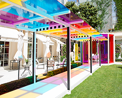 daniel buren creates a chromatic landscape in the gardens of hotel le bristol paris