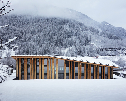 kengo kuma's timber office building sits by the base of mont-blanc