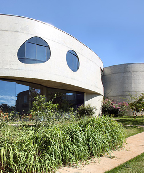 curving concrete house in brazil by ruy ohtake hosts a collection of design objects