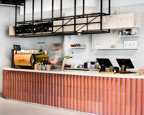 techne mixes natural, graphic and brass elements inside poacher & hound café in australia