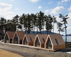 zai shirakawa organizes shingle-clad N village by the coast in japan