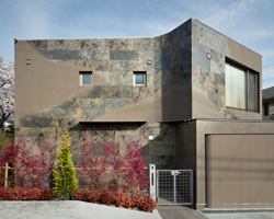 JP architects sandblasts stone to create triton house's façade in osaka