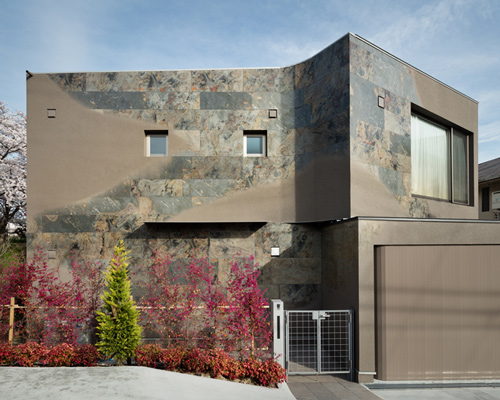 JP architects sandblasts stone to create triton house's façade in osaka