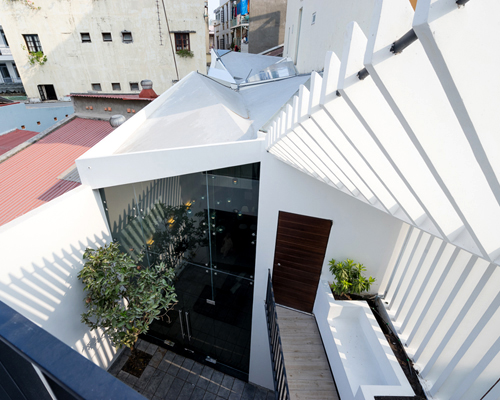 AD+ studio links three houses in ho chi minh city with folded roof system