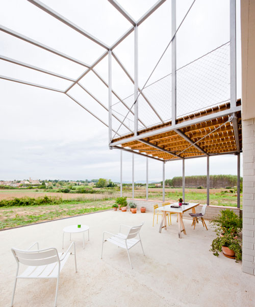 anna and eugeni bach attach large frame canopy to country home in spain