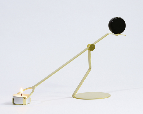 laura bin portrays dynamic between earth + fire in rising balance candleholder