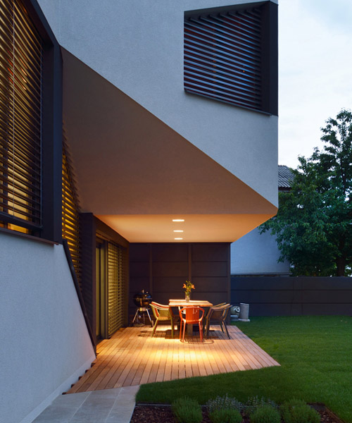 elastik + hikikomori's mezzanine house in ljubljana uses a cantilever to shelter exterior terrace