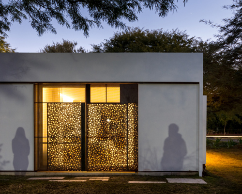FCP arquitectura's mooe house in argentina contrasts white walls with perforated panels
