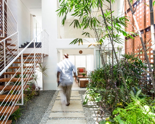 perforated corten façade provides ventilation for LIJO RENY's breathing wall residence