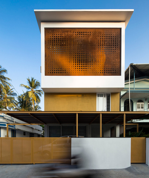 perforated corten façade provides ventilation for LIJO RENY's breathing wall residence
